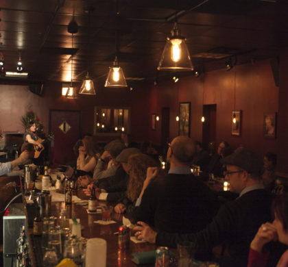 Patrons watch from the bar as Abbi Rajasekhar (cq) performs at High Hat Club's grand opening, Oct. 4, 2014.  (Kristan Lieb/For the Chicago Tribune)