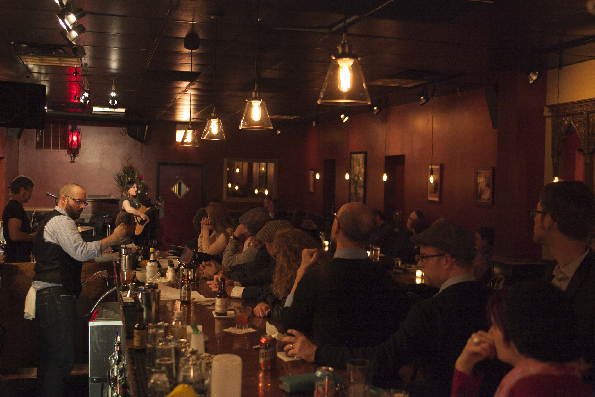 Patrons watch from the bar as Abbi Rajasekhar (cq) performs at High Hat Club's grand opening, Oct. 4, 2014. (Kristan Lieb/For the Chicago Tribune)
